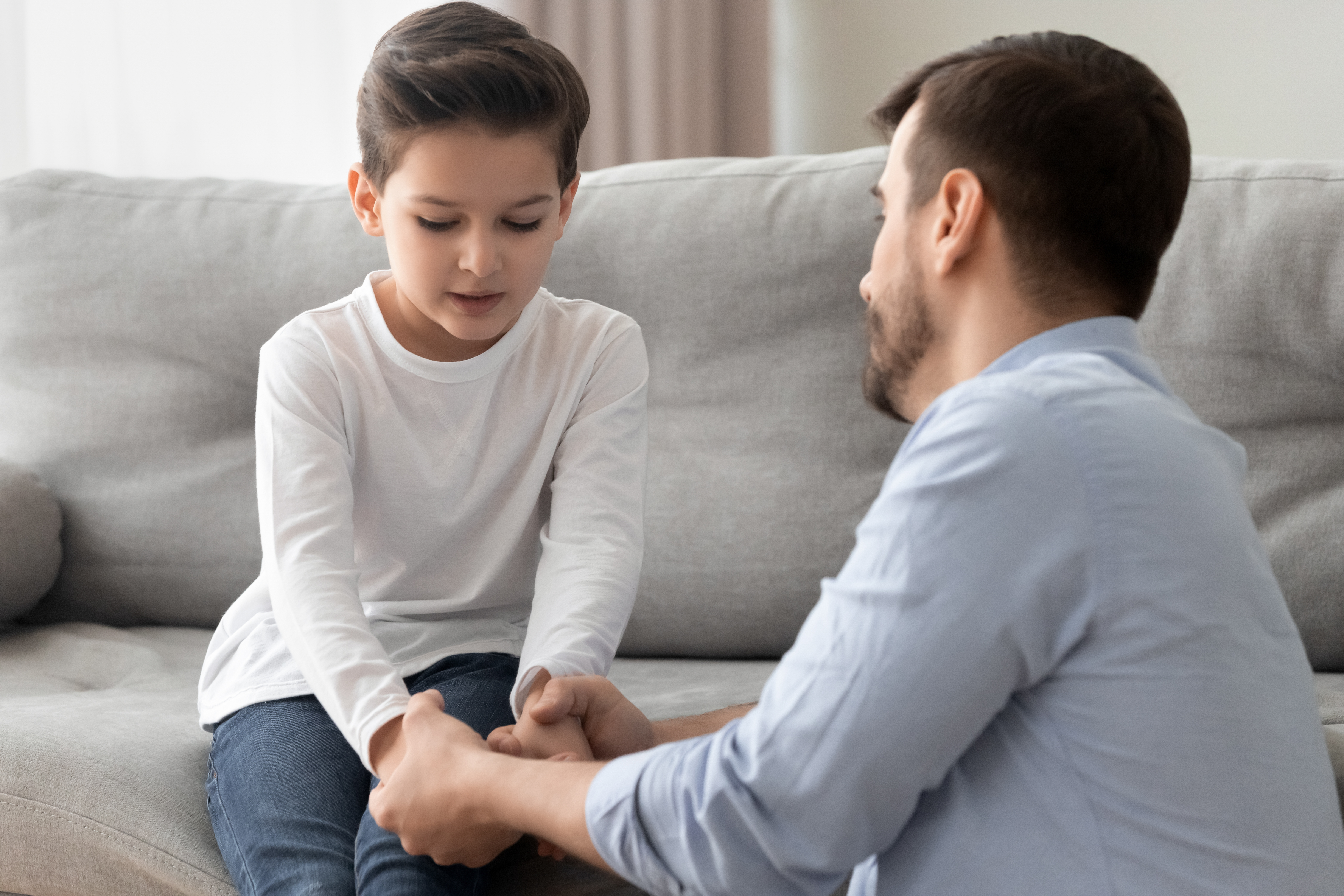 Sad boy is talking to his father | Source: Shutterstock.com