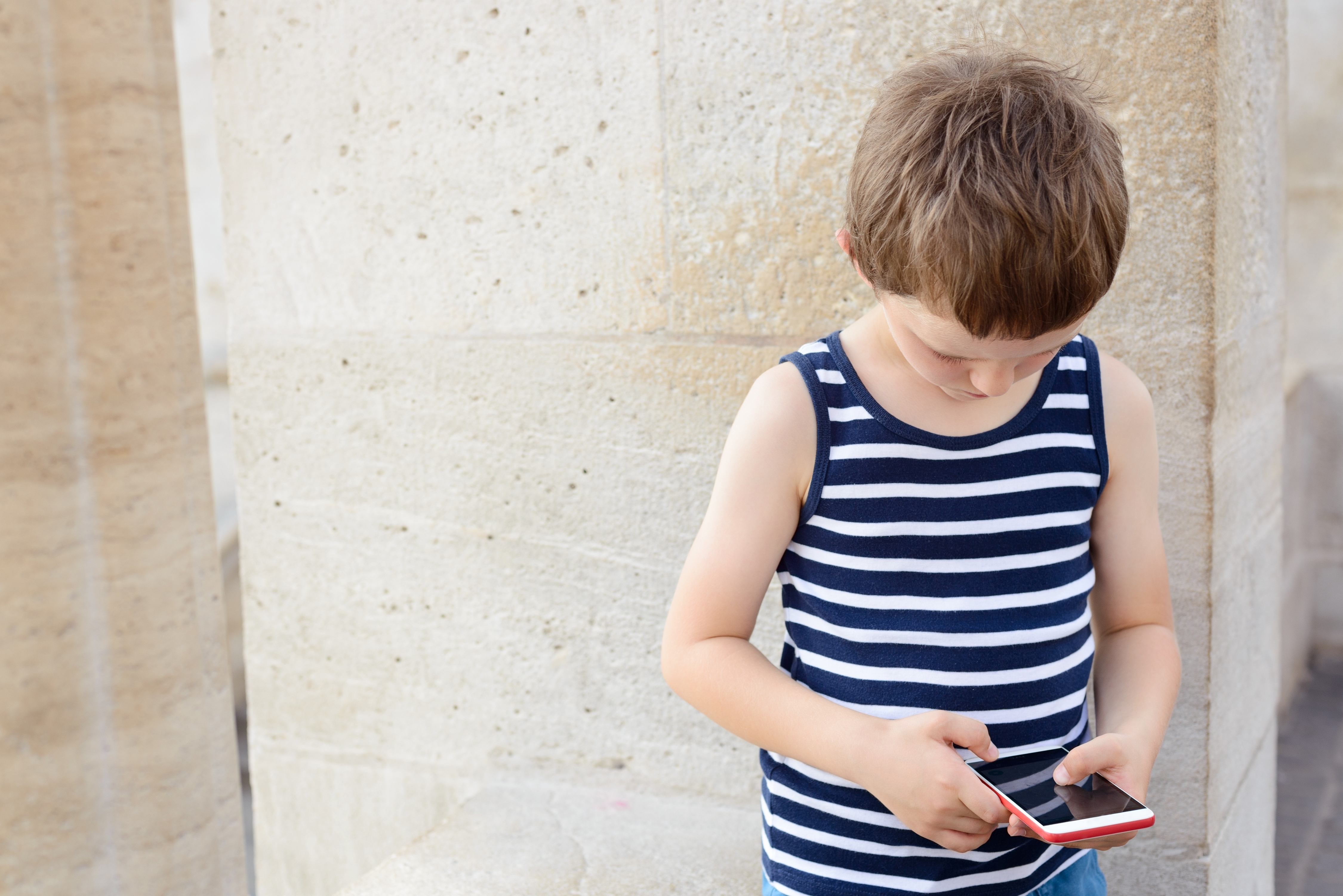 Little boy with the phone | Source: Shutterstock.com