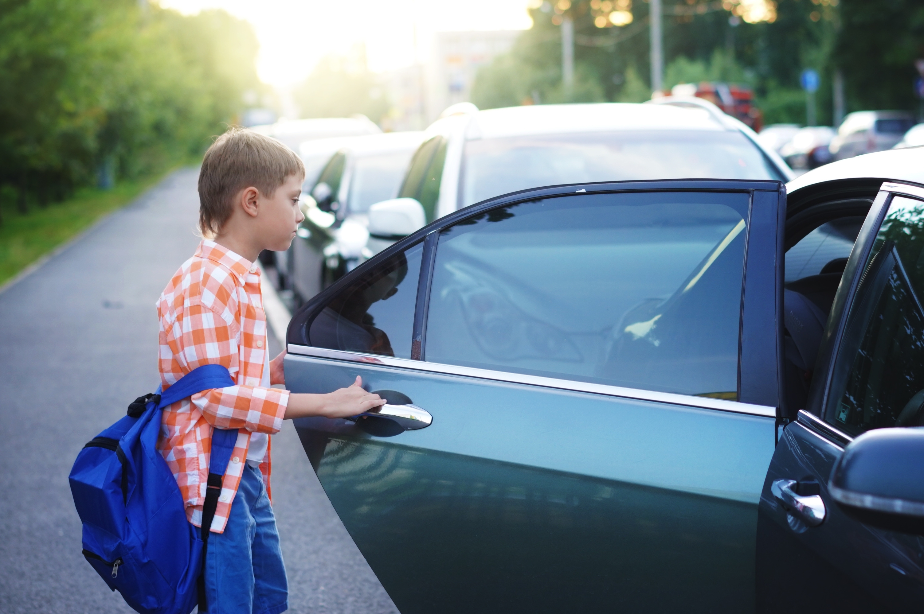 Young boy getting out of the car | Source: Shutterstock.com