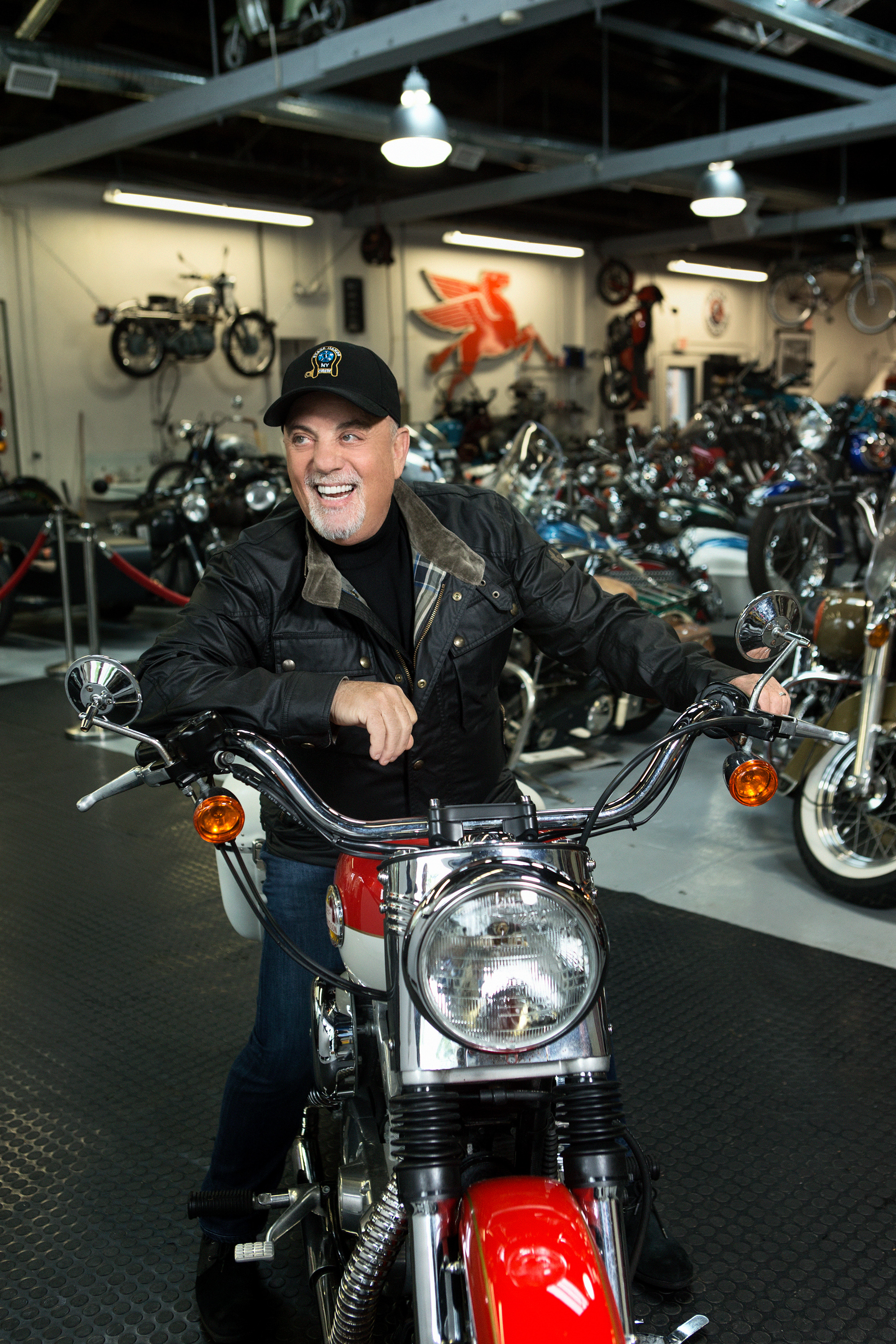 Billy Joel poses on a motorcycle in his store, 20th Century Cycles, on May 16, 2018 in Oyster Bay, New York | Source: Getty Images