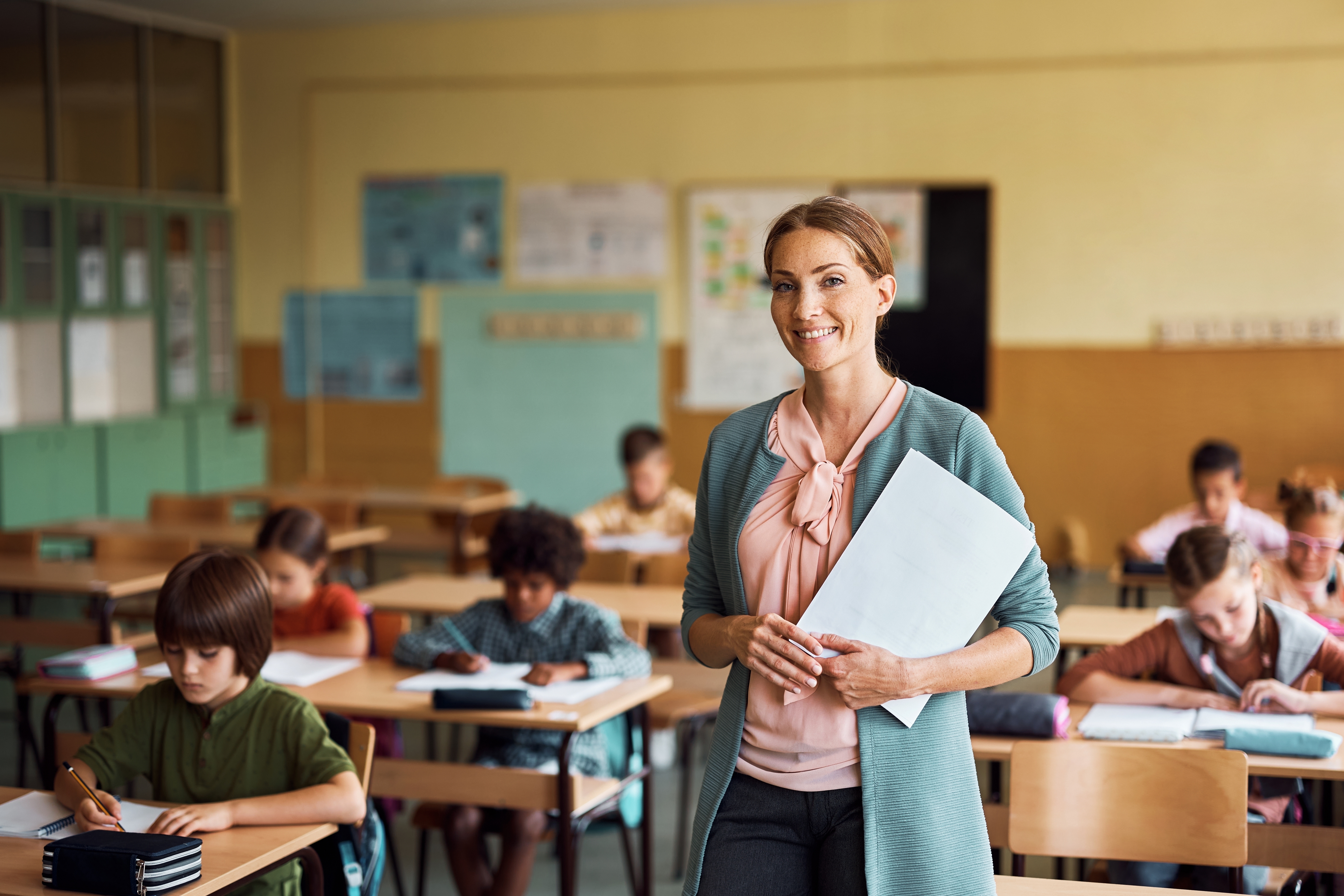 Teacher in classroom | Source: Shutterstock